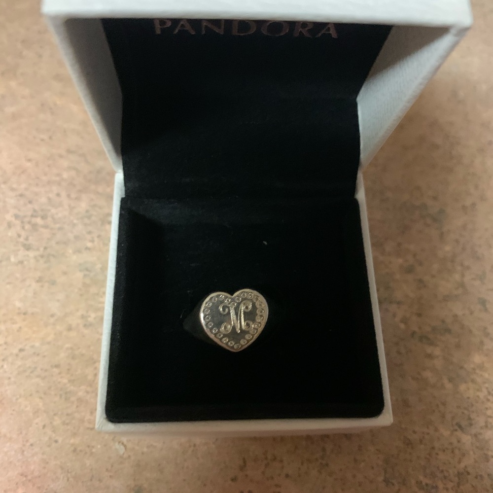 Pandora M ring with studs around it.
